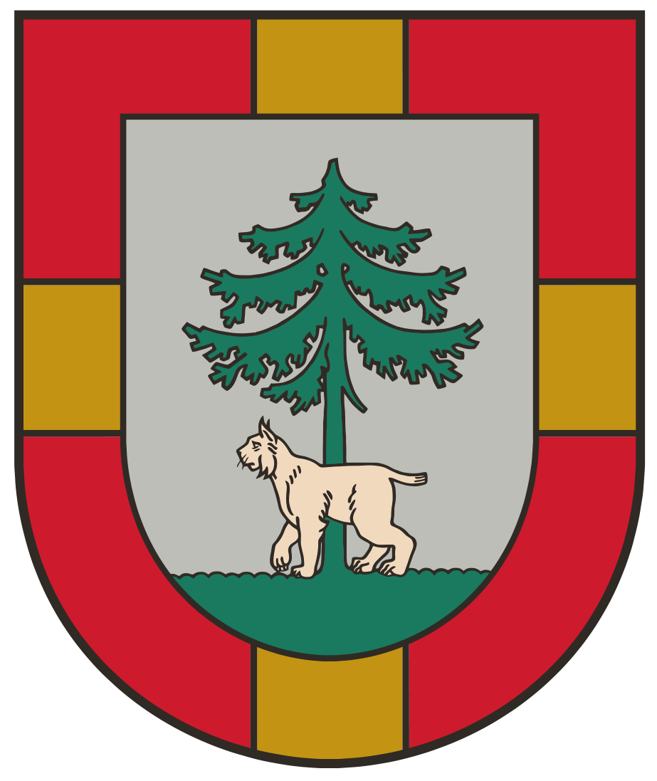 Coat of arms featuring a green tree and a beige bear walking on a gray background, framed by a red and yellow shield design.